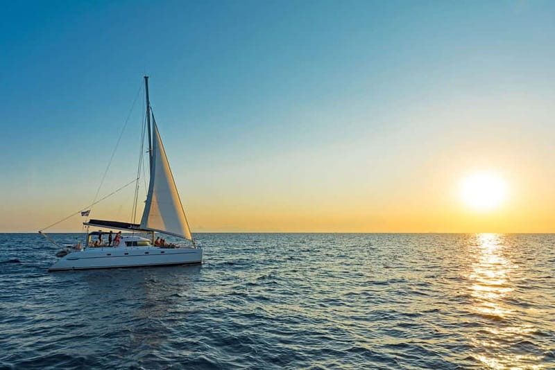 Athens: Half-Day Sunset Catamaran Cruise with Meal & Drinks - Watching the sunset from the catamaran