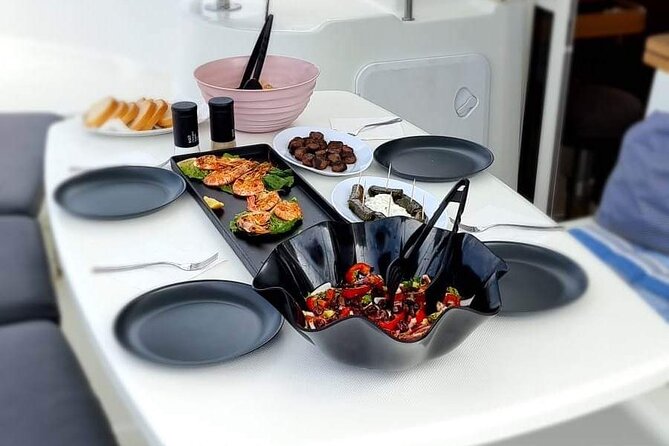 Catamaran Day & Sunset Cruises with meals Drinks and transportation - Sailing past Mykonos and the little pirate island