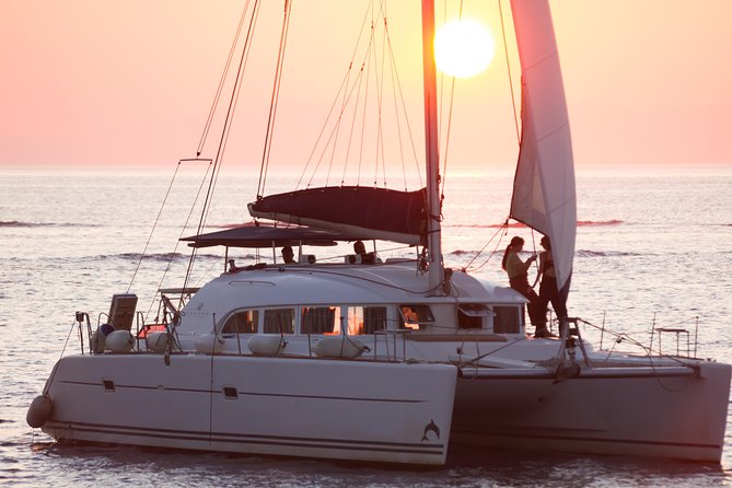 Catamaran Day & Sunset Cruises with meals Drinks and transportation - Rhenia, clear water, and the long swimming stop