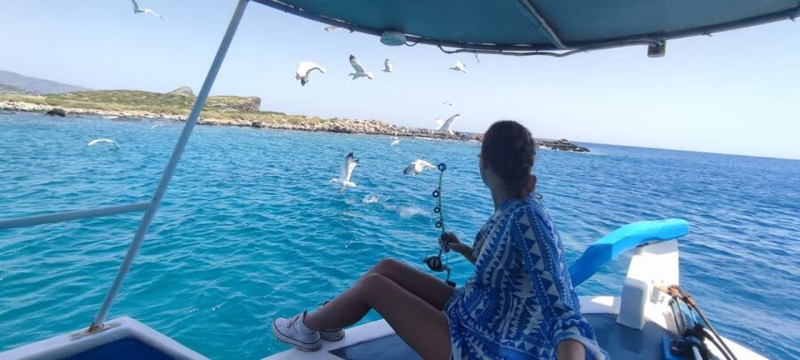 Crete: Fishing & Swimming Boat Cruise with Lunch & Drinks - Views toward Spinalonga and the Elounda coast