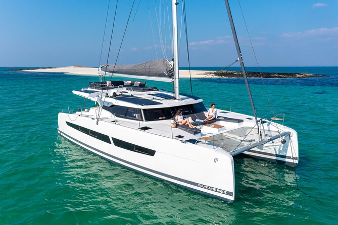 Mykonos: Brand-New Catamaran Cruise with Meal, Drinks & Transport - Sailing toward Rhenia or Mykonos southern coast