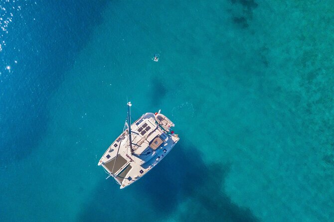 Mykonos: Private Catamaran Cruise—Hotel Pickup, BBQ & Drinks - Delos adds an ancient Greek centerpiece