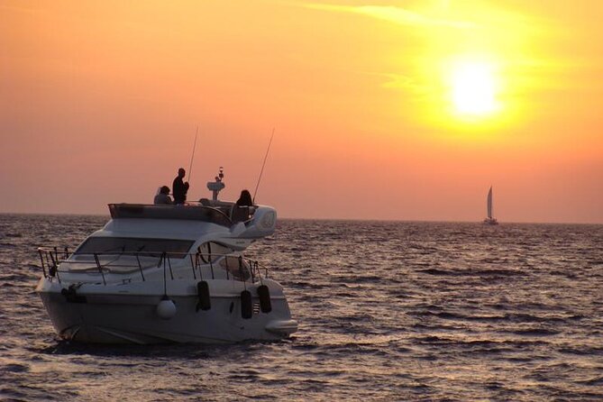 Private Motor Yacht Cruise with BBQ, Open Bar & Transfers - The lighthouse and caldera coast from sea level