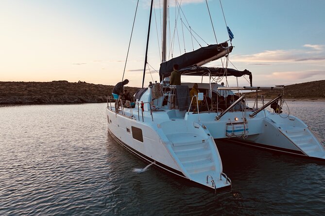 Private Mykonos Catamaran Day Cruise with Meals & Water Toys - Stop three: Rineia for swimming and quiet coves