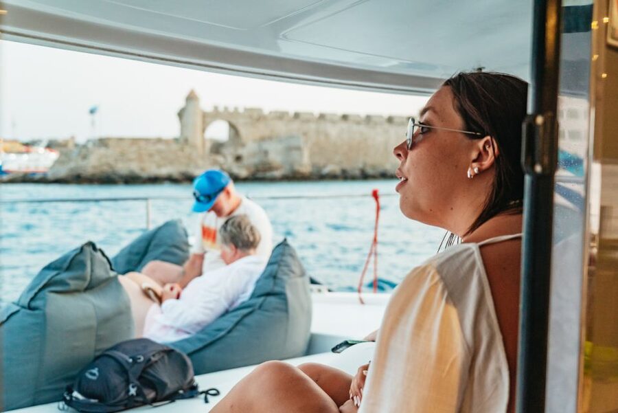 Rhodes: Sunset Catamaran Cruise with Dinner Buffet & Drinks - Sunset on the return to Rhodes Town