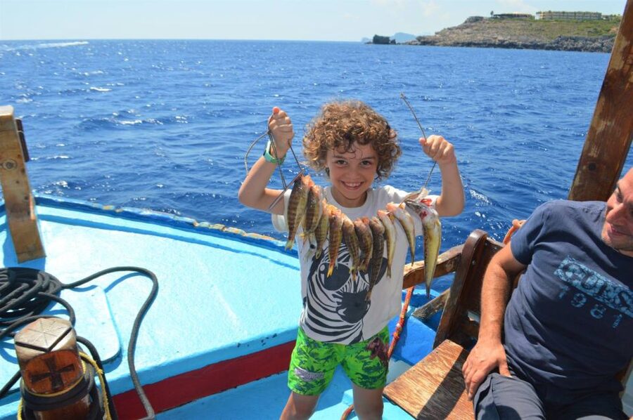 Rhodes Town: Fishing Boat Trip with Fish Meal and Swim Stops - Leaving Mandraki Harbor beside Evangelismos church