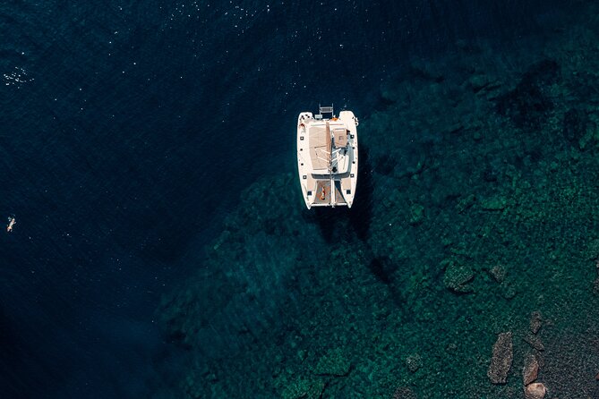 Romantic Sunset Catamaran Caldera Cruise incl. Meal & Drinks - Red Beach and the volcanic coast