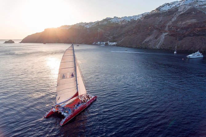 Sailing Catamaran Cruise in Santorini with BBQ, Drinks and Transfer - Red Beach from the sea