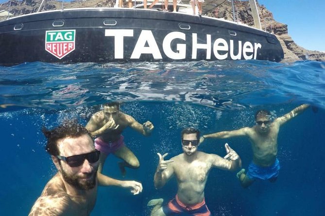 Santorini Adventurous Catamaran Experience with Snorkeling - Red Beach: striking cliffs and a short swim