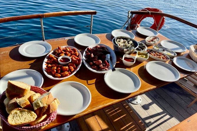 Santorini Caldera Day Traditional Cruise with Meal and Drinks - White Beach, the lighthouse, and Mesa Pigadia
