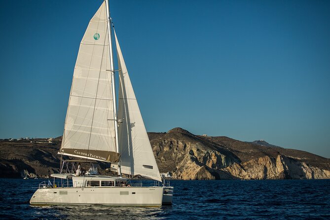 Santorini Caldera Gold Day Cruise with BBQ on board and Open Bar - Red Beach and White Beach from the sea