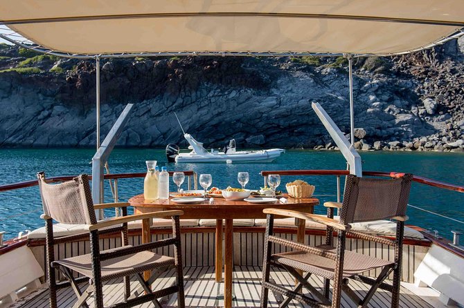 Santorini Caldera Sunset Traditional Cruise with Meal and Drinks - Thirassia: the first swim and the first meal