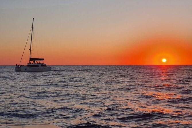 Santorini Classic Catamaran Cruise with BBQ, Drinks and Transfers - Red Beach and White Beach from the water