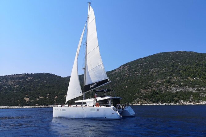 Santorini: Luxury Catamaran Cruise with Fresh Fish BBQ & Drinks - The lighthouse at Santorini’s southern tip
