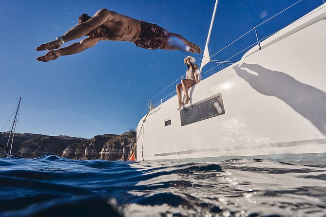 Santorini Oia: Luxury Sunset Cruise with Fresh Fish BBQ & Drinks - Lighthouse views and the southern coast