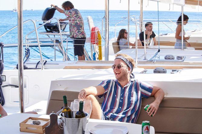 Santorini Platinum Catamaran Cruise with Meal, BBQ and Open Bar - The Akrotiri lighthouse and the volcanic coast