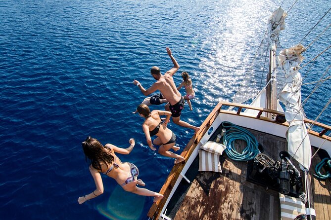 Santorini Sunset Dinner Cruise Including Nea Kameni Visit - Sailing away from Santorini’s caldera cliffs