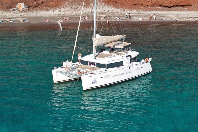 Santorini Sunset Sailing Cruise: Dinner, BBQ, Open Bar, Transfers - Red Beach gives the afternoon a strong start