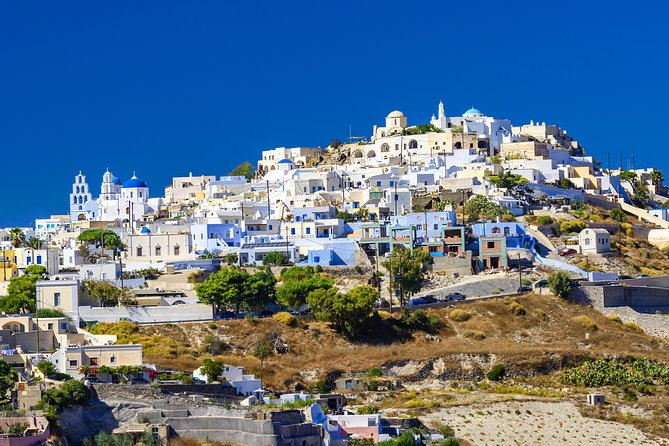 Sunset In Oia & Traditional Villages Bus Tour - Walking uphill through former capital Pyrgos