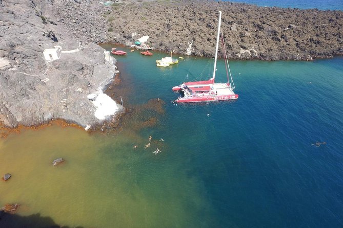 Sunset Sailing Catamaran Cruise in Santorini with BBQ and Drinks - Red Beach from the water
