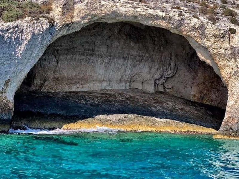 Zakynthos: Blue Caves and Navagio Bay Swim Cruise - Entering the Blue Caves by small boat